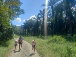 Family running on road.