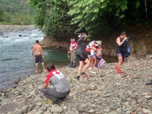 People on riverbank. 