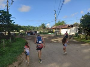 Family running on road.