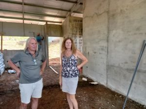 Two people inspecting a house.