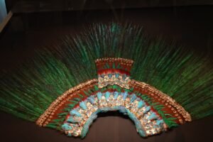 A headdress adored with Quetzal feathers, thought to belong to the Aztec ruler Moctezuma II, or perhaps belonging to a high-ranking priest.