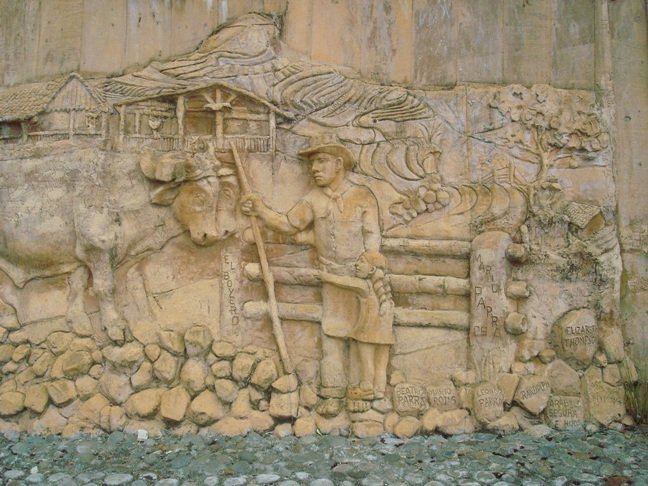 Detail of a huge wall carving (210 feet or 64 meters in length) in front of a church in San Antonio, showing a Boyero and a pair of Oxen. c/o wikicommons.