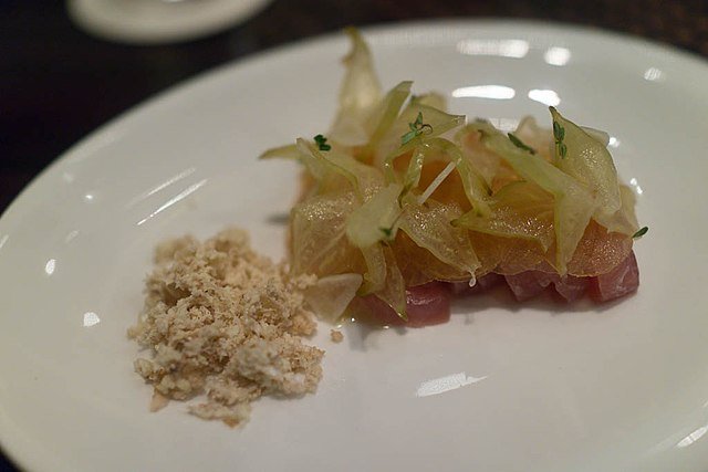 "Hamachi Carambola: Citrus cured hamachi, pickled starfruit and garlic, freshly grated walnuts" - a Japanese sushi dish. c/o Charles Haynes, wikicommons.