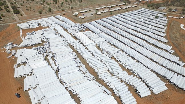 Spent wind turbine blades before being buried in a landfill.